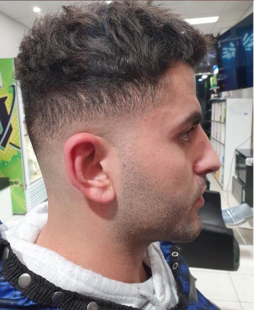 Textured crop with mid fade at Saba Barbershop